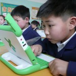 Child sat at desk using laptop