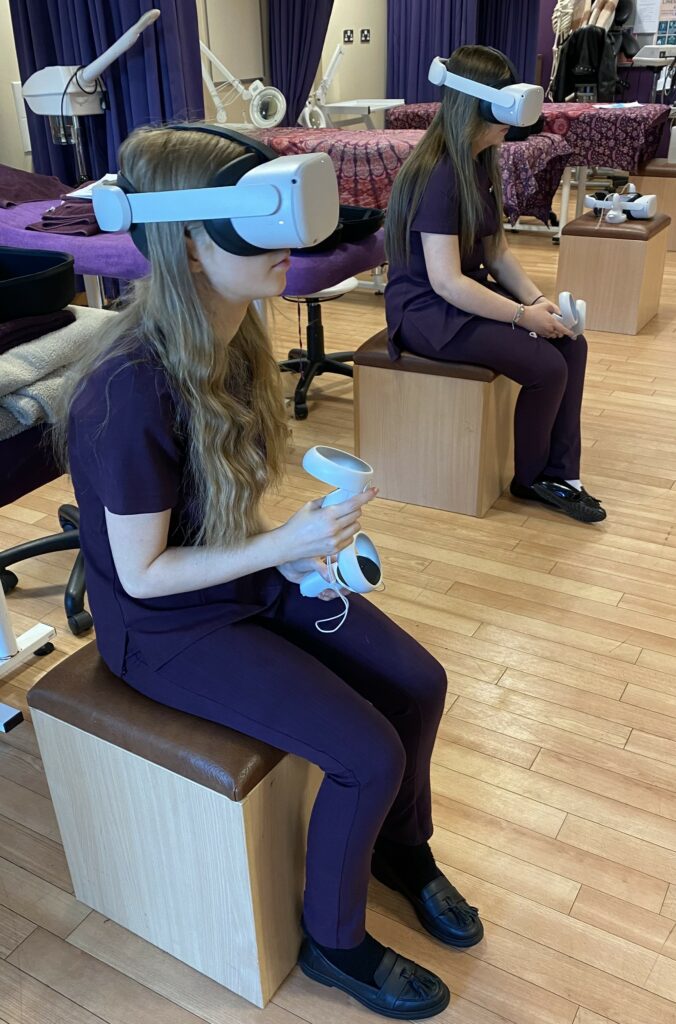 Two students wearing virtual reality headsets in a beauty salon